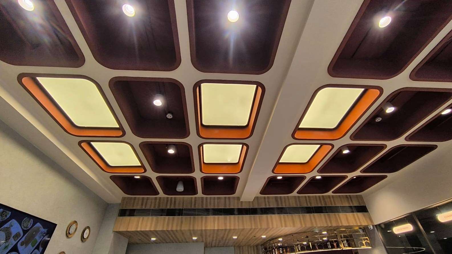 Actual BION installation with multiple rounded luminous ceiling panels in a commercial interior