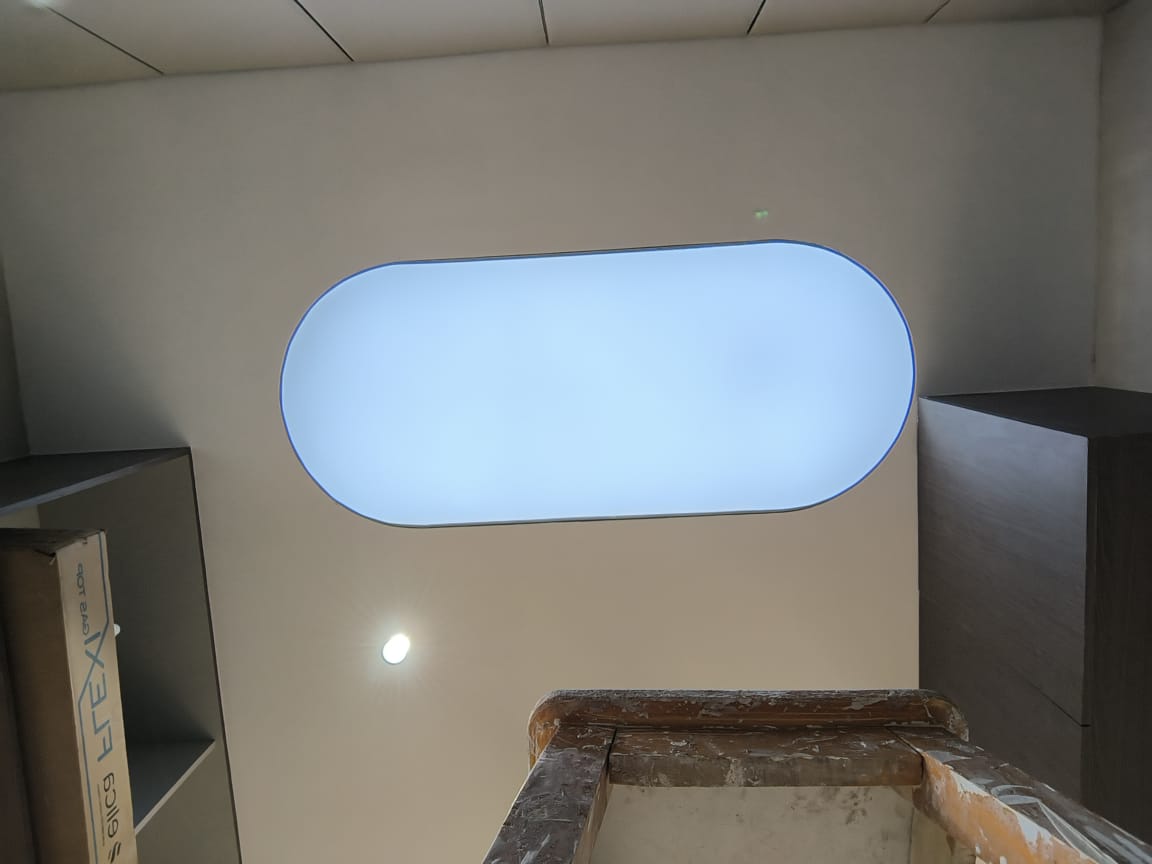 Actual BION rounded-rectangle plain-white backlit stretch ceiling detail